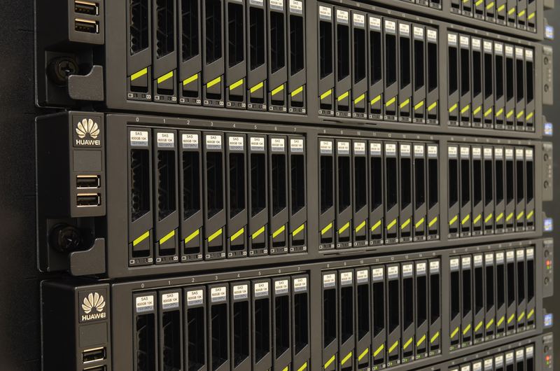 Two rack-mounted servers seen from the front, their rows of drive bays and status lights in close-up.